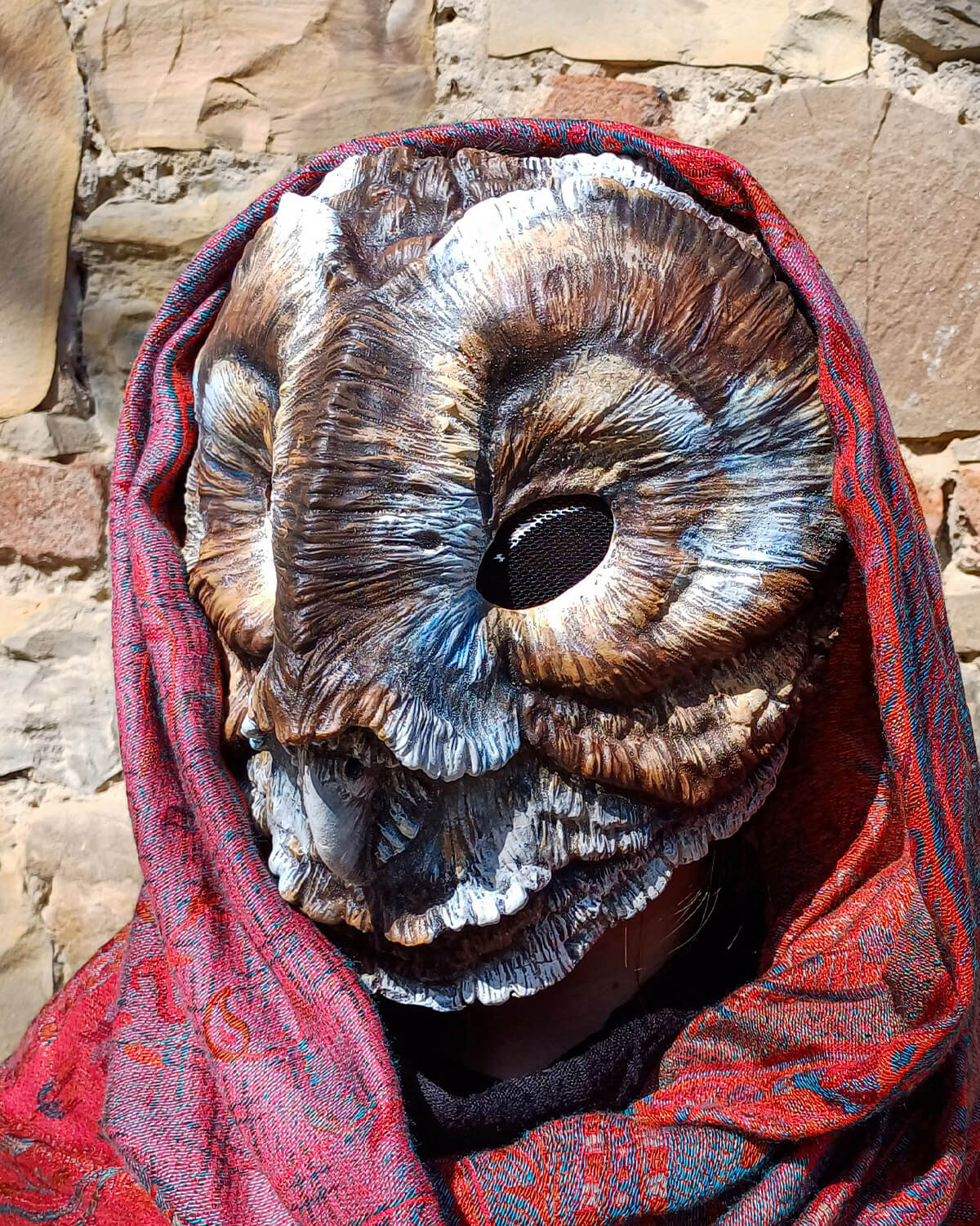 Side view of the Brown Barn Owl mask, showing the adjustable elastic straps for secure wear.
