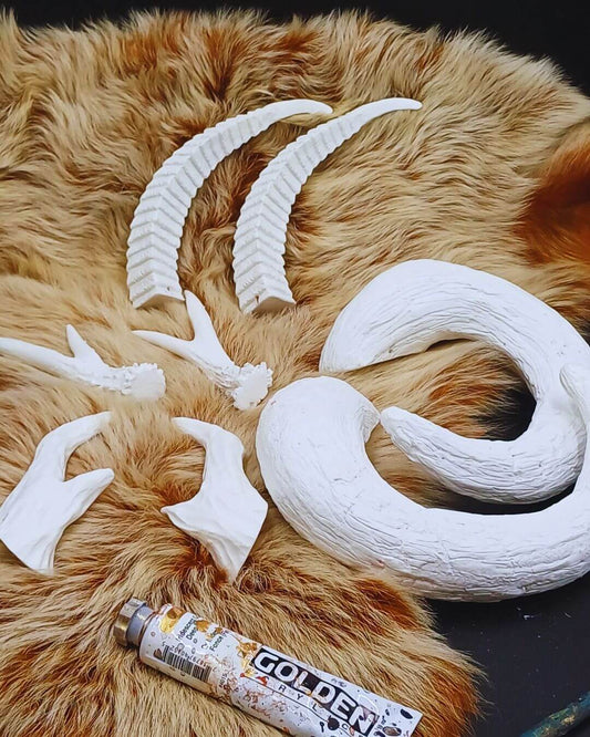 Set of blank resin horns on black background – handmade cosplay & LARP accessories for costumes and roleplay.