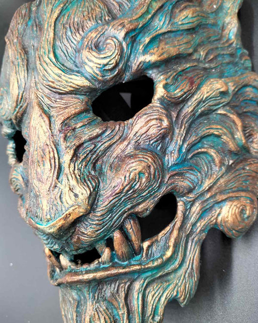 Details of handcrafted tiger mask with captivating oxidized colors