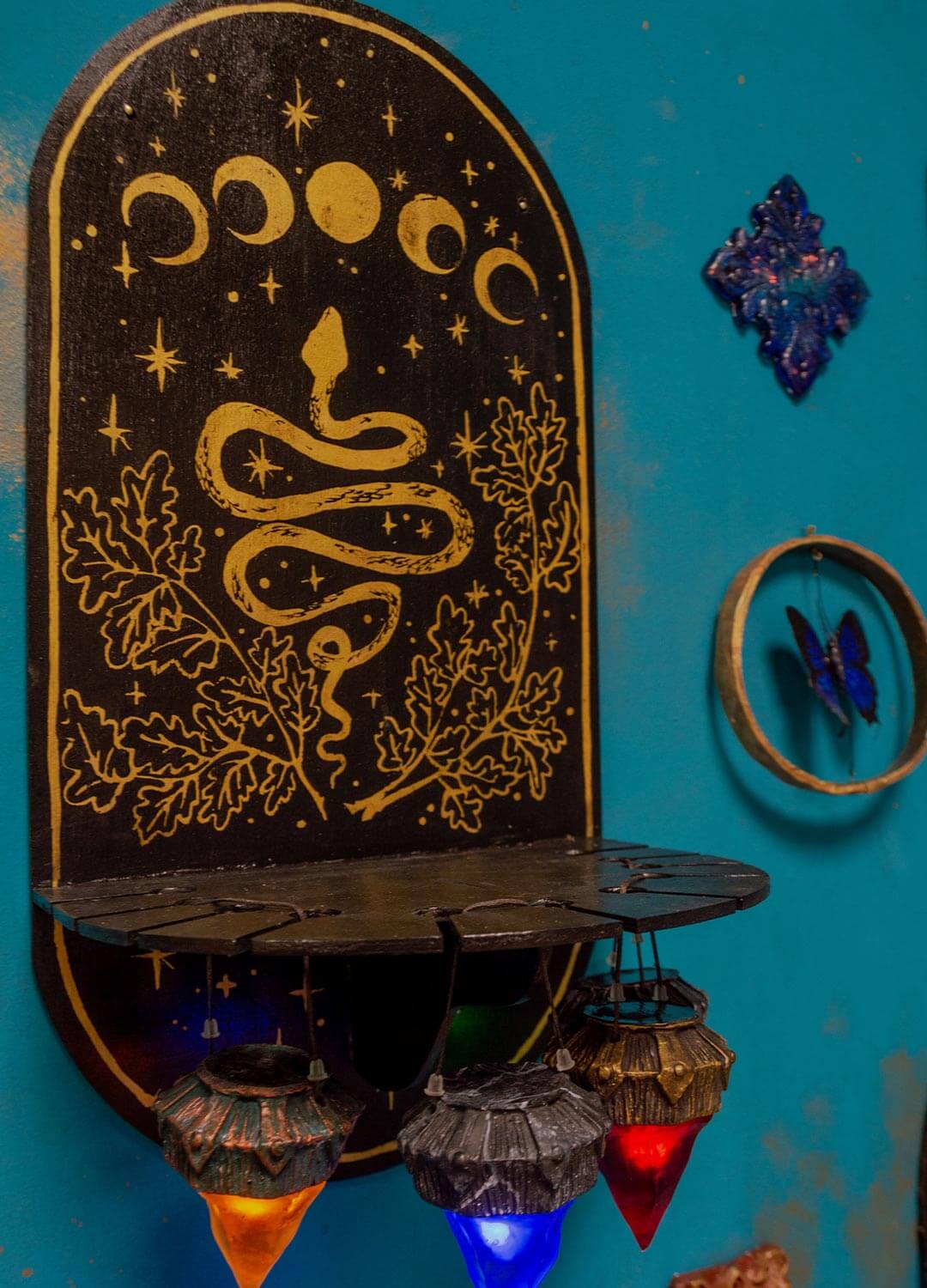 Custom wooden necklace holder, close-up of personalized carvings and paintwork, gothic craft.