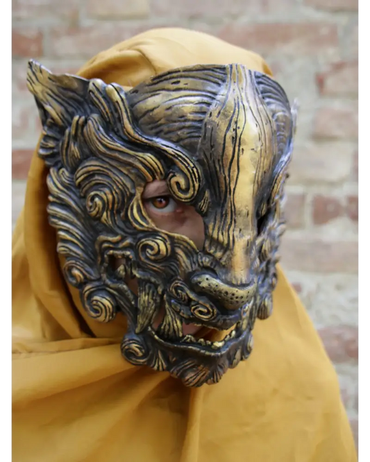 Black Oni mask for cosplay and LARP, demonic design with gold accents, handcrafted from durable resin, comfortable to wear with interior padding.