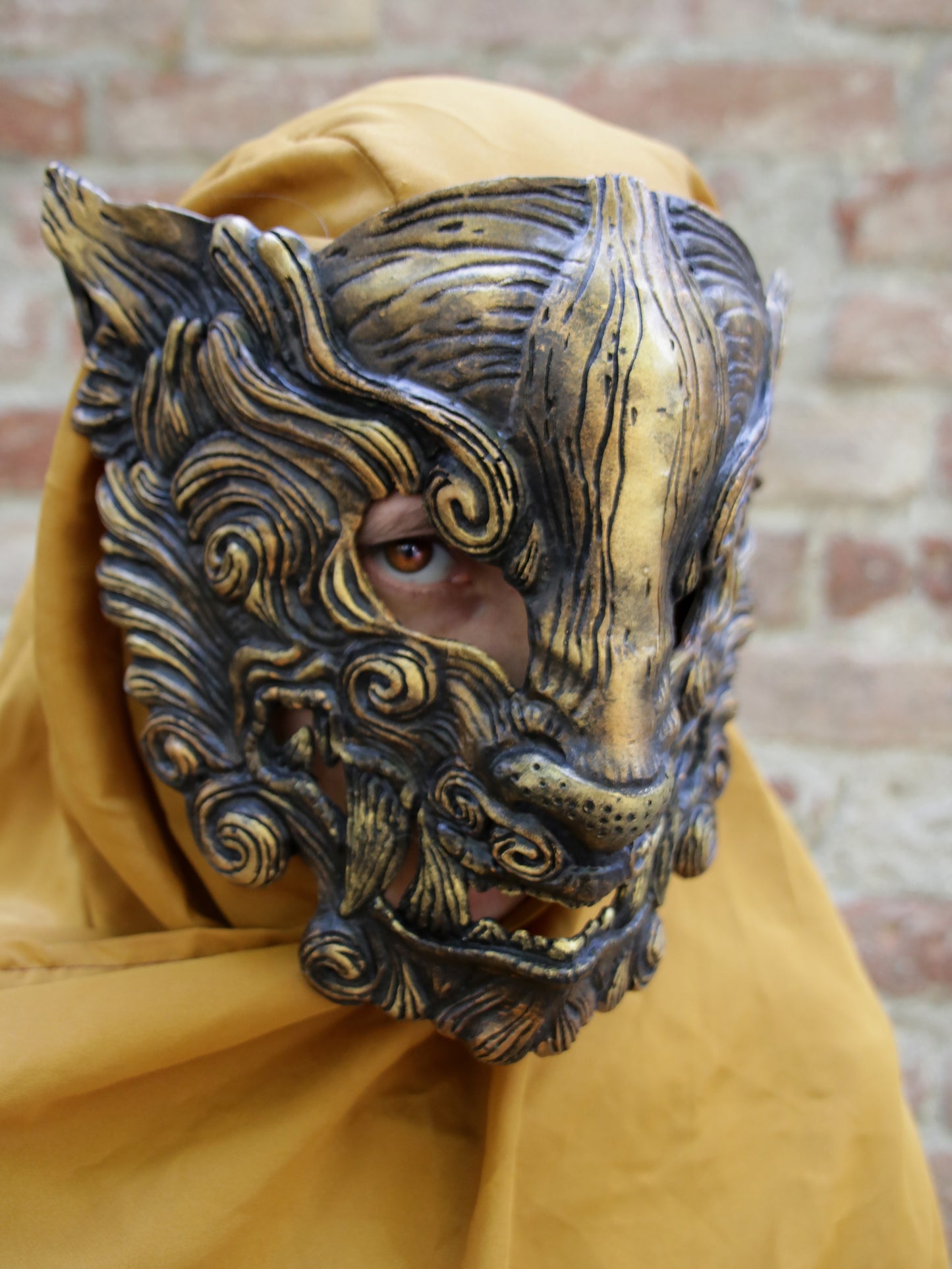 Black Oni mask for cosplay and LARP, demonic design with gold accents, handcrafted from durable resin, comfortable to wear with interior padding.