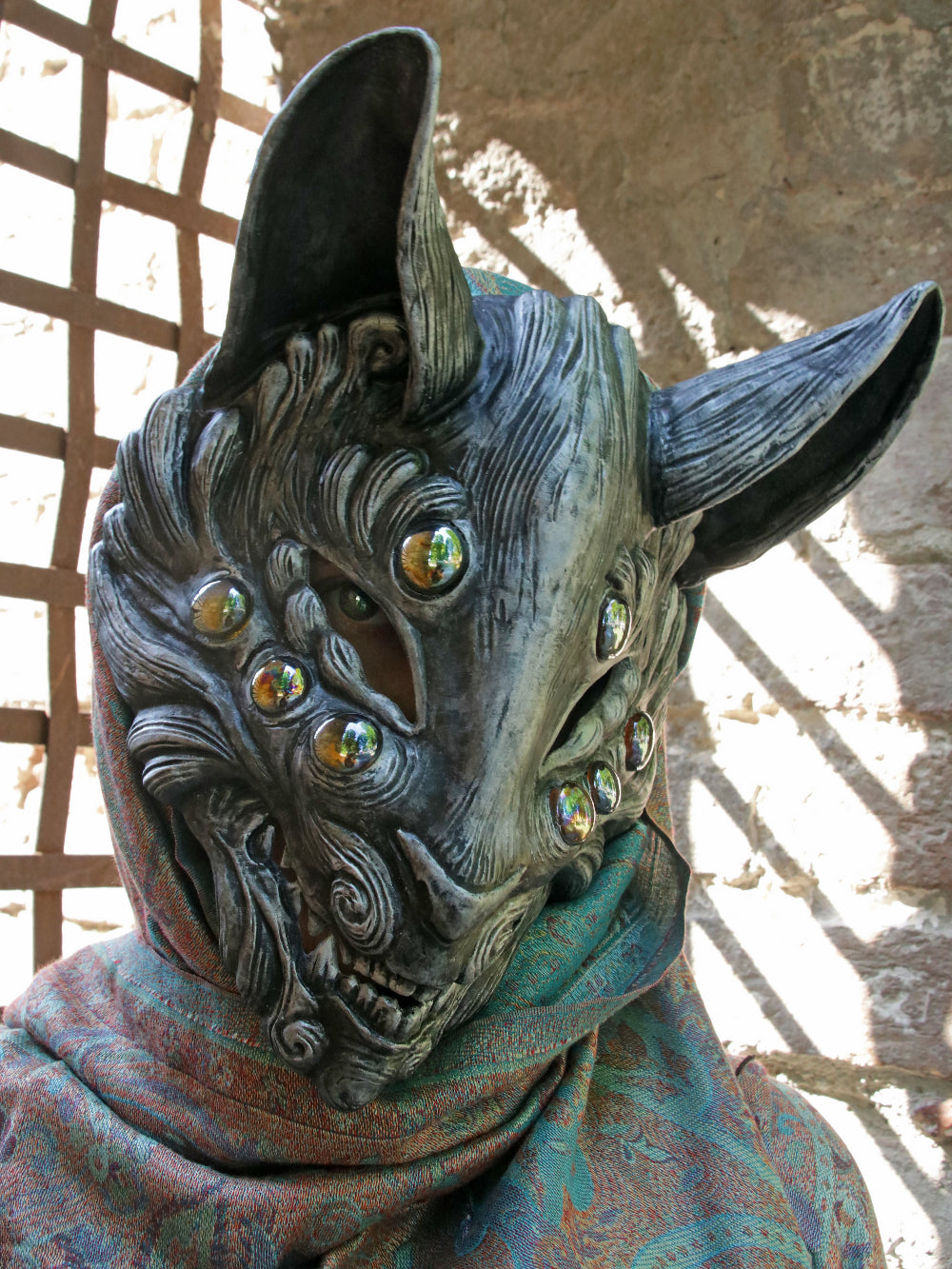 Adjustable and padded silver resin Kitsune mask, suitable for active events.