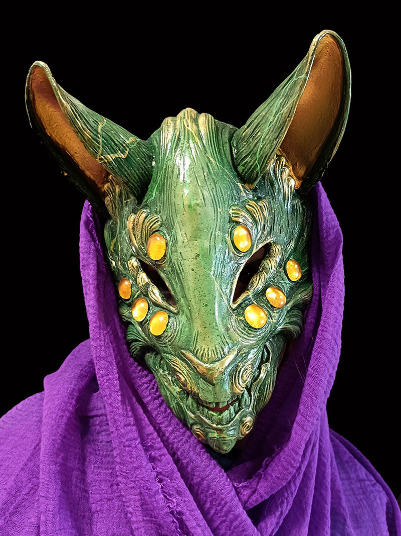 Striking jade resin Kitsune mask with intricate gem detailing.