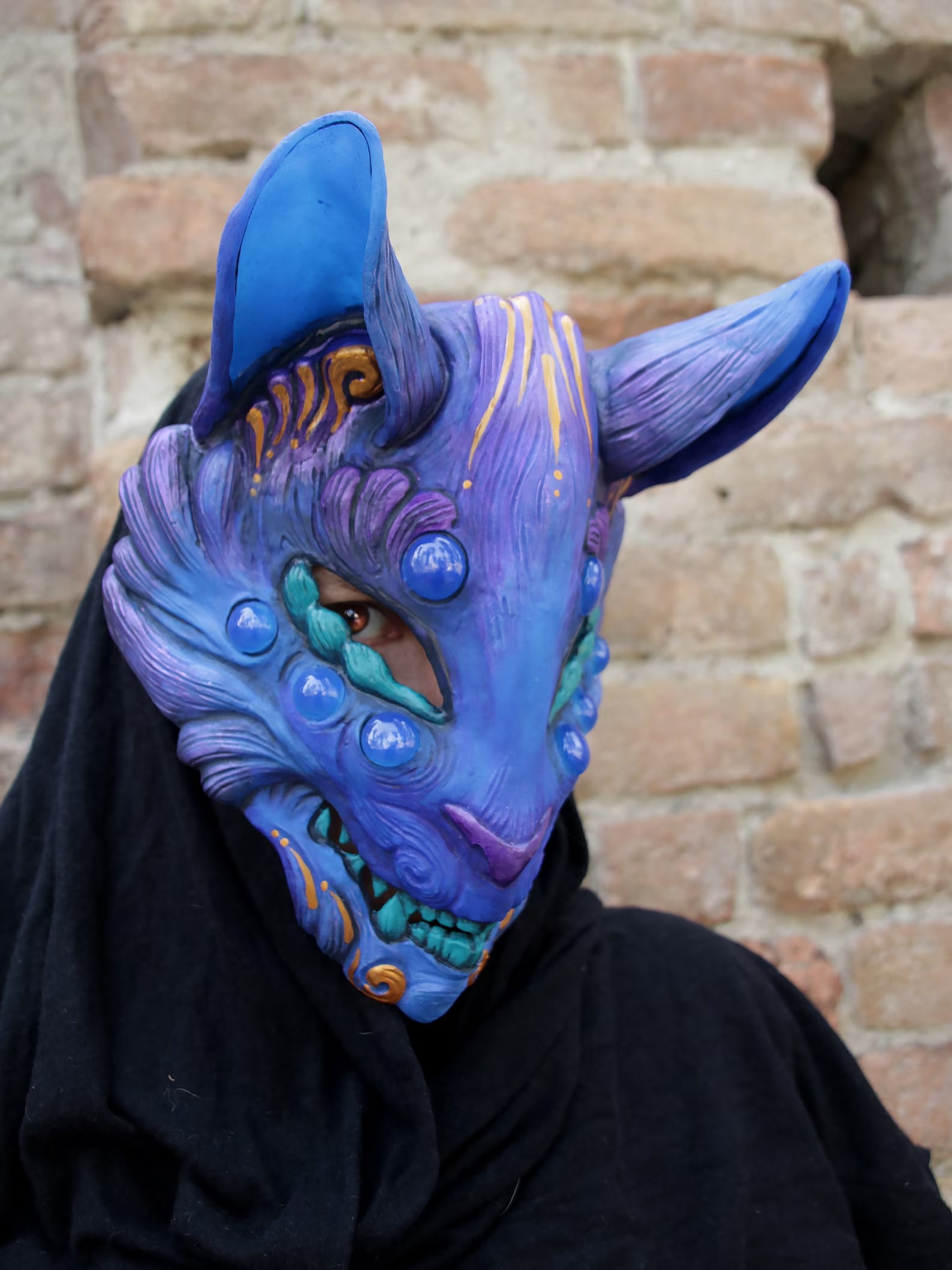Kitsune mask showcasing its unique glow-in-the-dark effect under UV light.