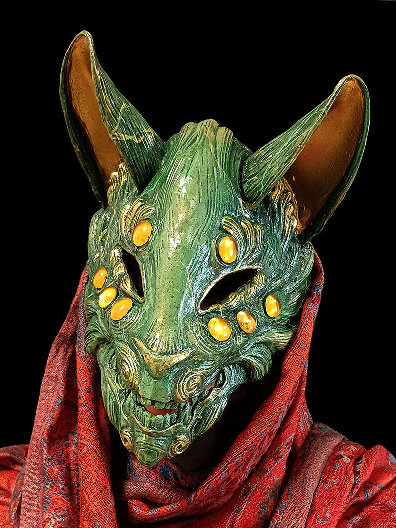 Detailed jade-colored resin mask of a mythical fox spirit (yōkai).
