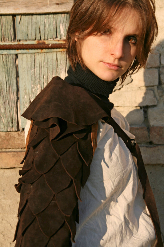 Examples of homemade gladiator armour pieces, possibly including shoulder pauldrons and chest pieces, inspiring viewers for their own DIY projects.

