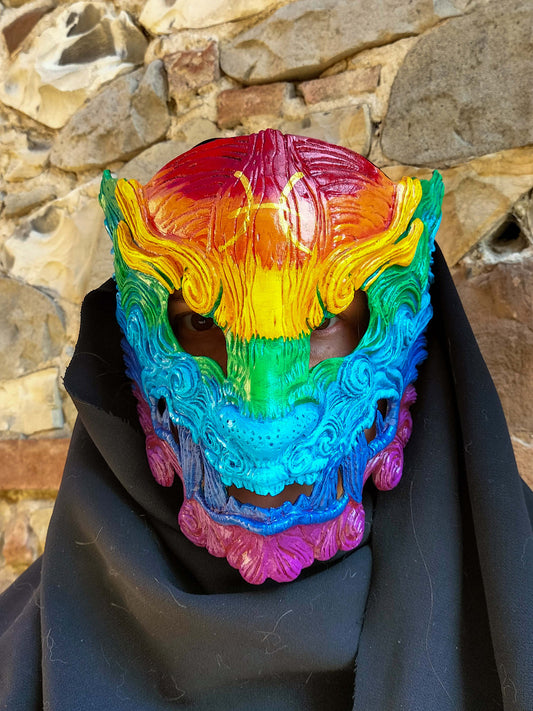 Hand-painted Pride Oni mask featuring vibrant rainbow colors for LGBTQ+ inclusivity.
