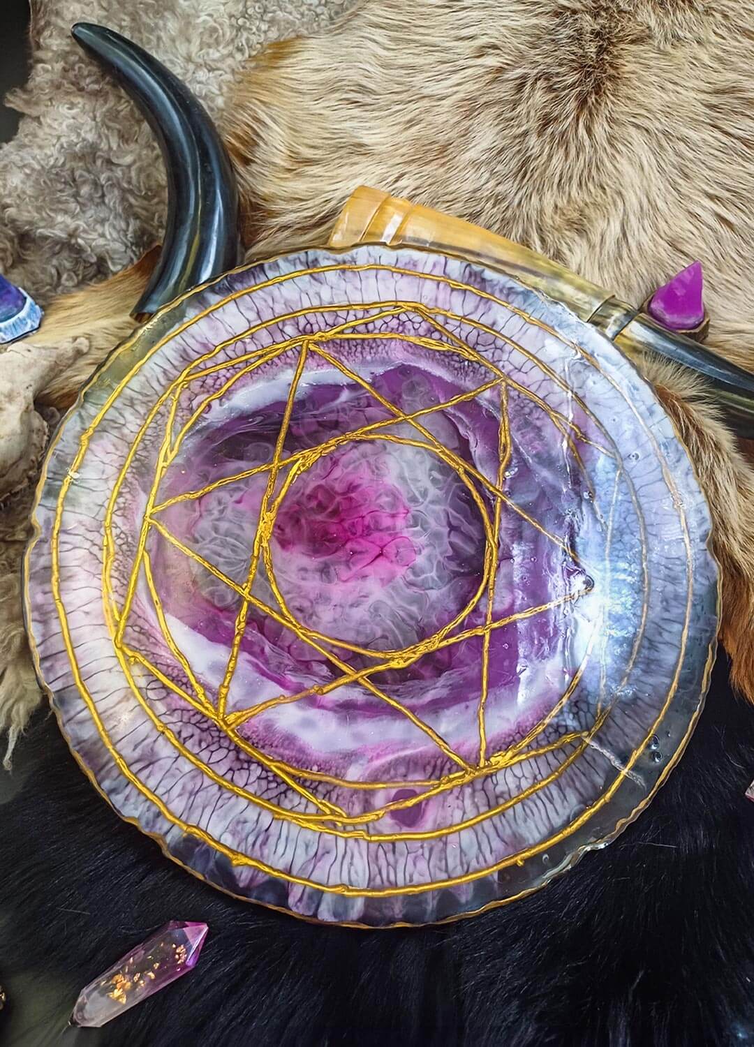 Handmade wooden ritual board with resin, close-up of hand-carved details