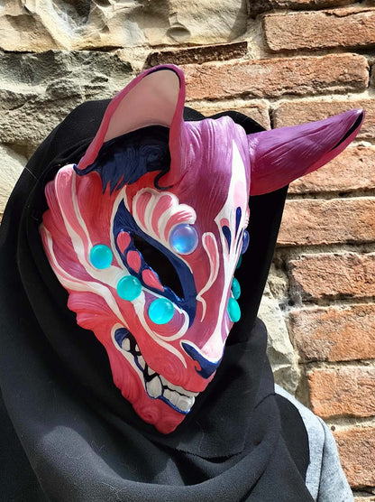detailed view of the resin craftsmanship and color-changing pigments in the Kitsune mask.
