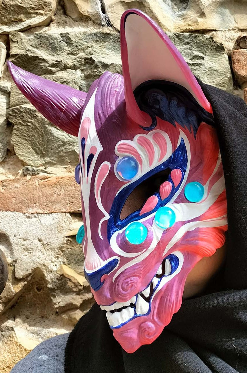 detailed view of the resin craftsmanship and color-changing pigments in the Kitsune mask.
