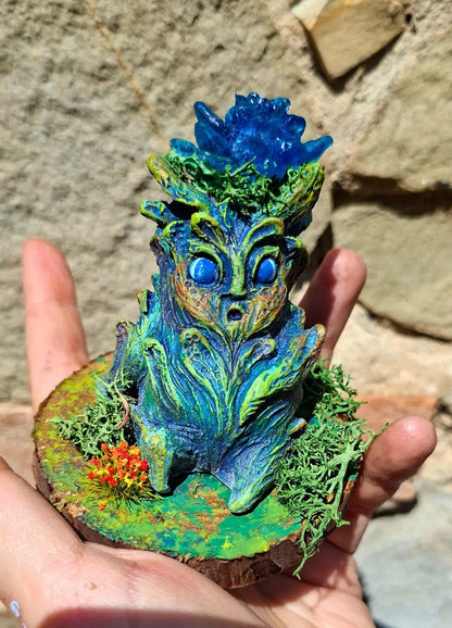 Decorated wooden display base with preserved flowers and lichen for the Lumen Mandrake.