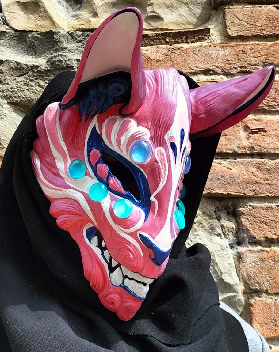 photochromic Kitsune mask transforming color in sunlight.
