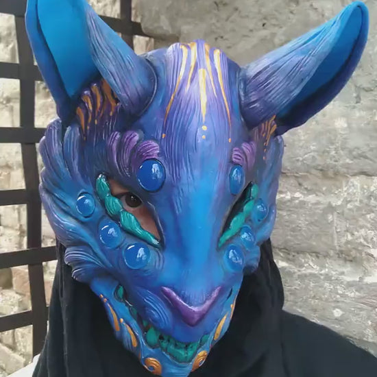 Kitsune mask showcasing its unique glow-in-the-dark effect under UV light.
