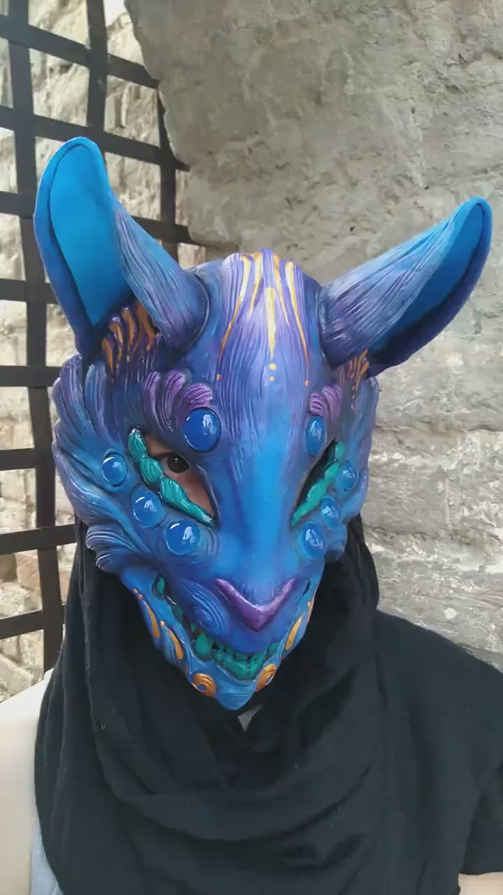 Kitsune mask showcasing its unique glow-in-the-dark effect under UV light.
