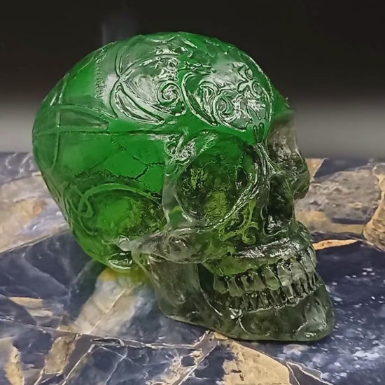 UV light illuminating fluorescent pigments in resin skull, glow-in-the-dark effect.