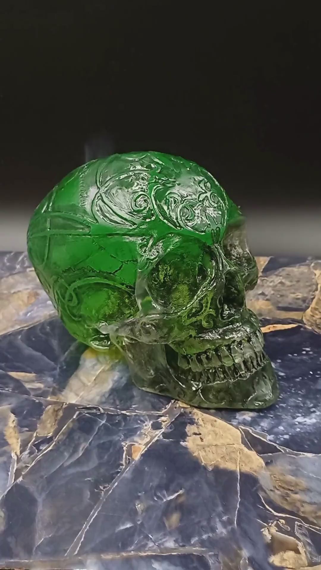 UV light illuminating fluorescent pigments in resin skull, glow-in-the-dark effect.