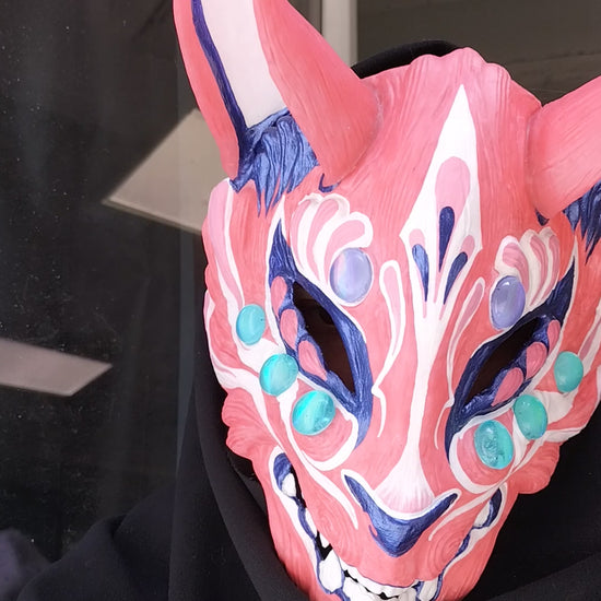 comfortable and adjustable resin Kitsune mask showcasing its color transformation on a model.
