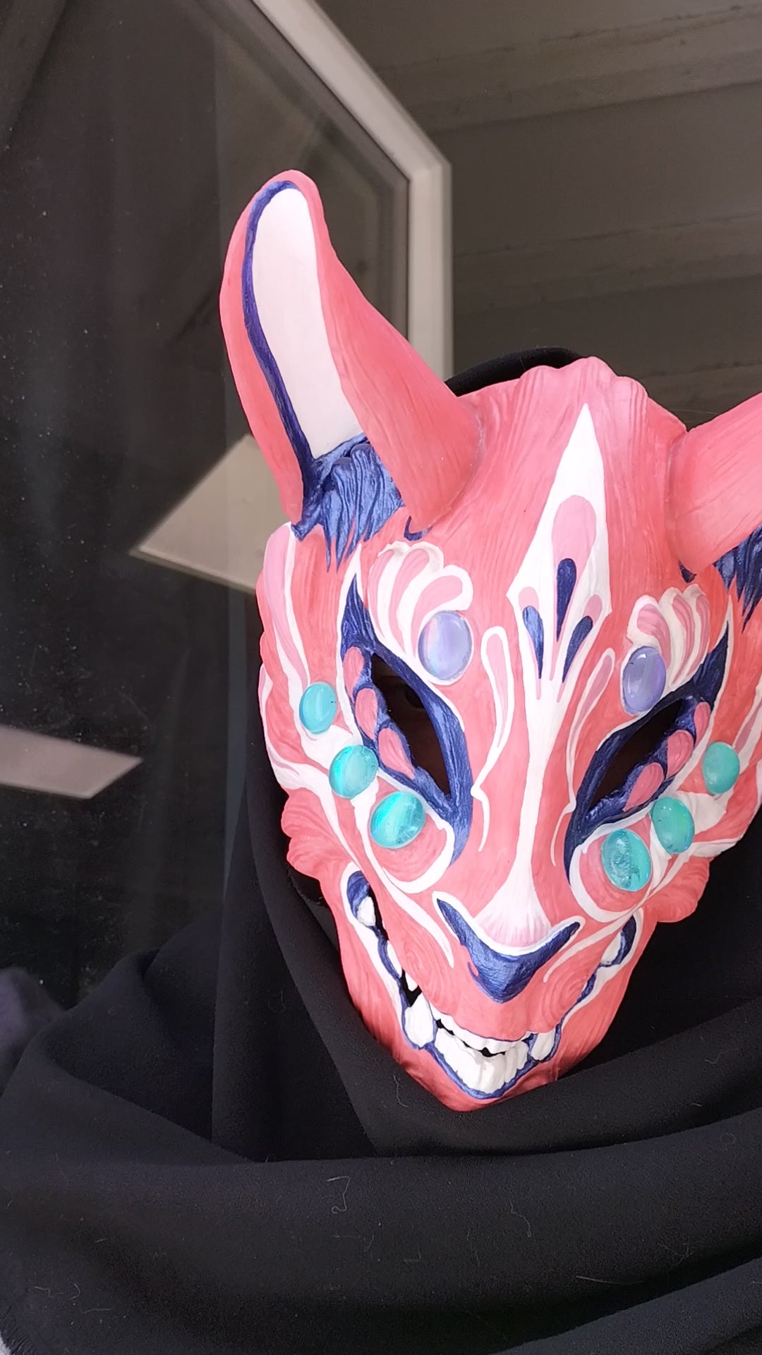 comfortable and adjustable resin Kitsune mask showcasing its color transformation on a model.
