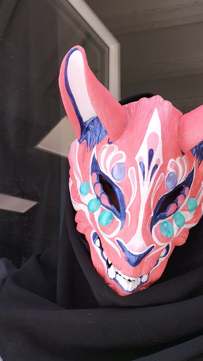 comfortable and adjustable resin Kitsune mask showcasing its color transformation on a model.
