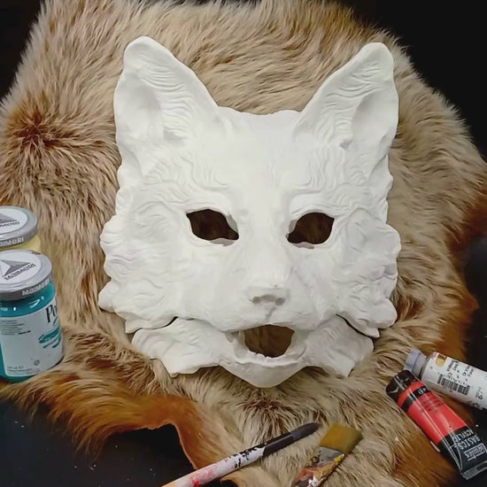 Huli Jing mask blank with articulated jaw, showing movable parts.