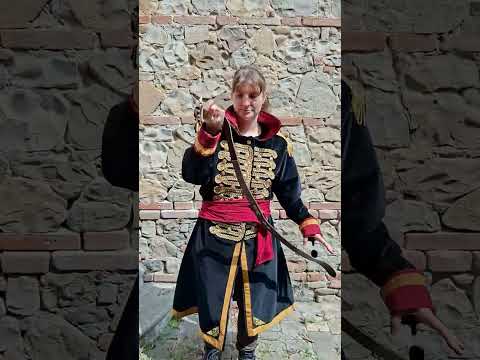 Video demonstration of the premium custom-tailored Warhammer 40k Commissar coat by Chimerical Dragonfly, showing the movement of the Italian velvet fabric, hand-cast props, and how to take body measurements.