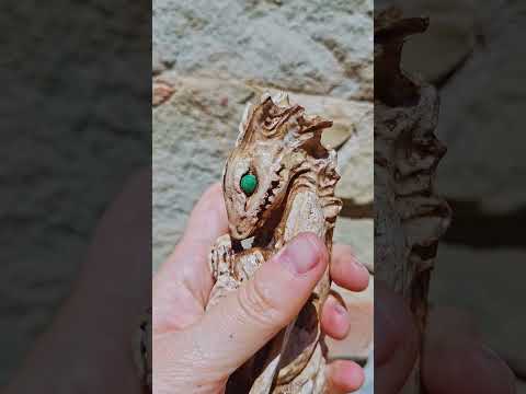 A short video demonstrating the detailed 3D textures of the Dagon Idol dragon statue, showing the hand rotating the classic weathered bone finish and the translucent Crystal Lagoon resin edition to reveal light-reflecting sea glass patterns from multiple angles.