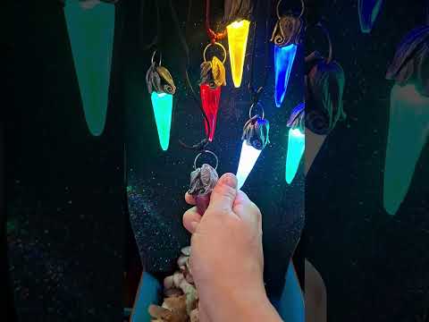 A short product video demonstrating the smooth twist activation system of the soulbound crystal pendant, showcasing the internal LED turning on to emit a magical ambient glow, highlighting the hand-sculpted skull parts from multiple 3D angles.