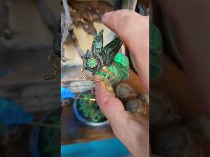 Video demonstration showing the twist activation of the integrated LED light, illuminating the steampunk insect brooch in a dark room for LARP and cosplay ambiance.