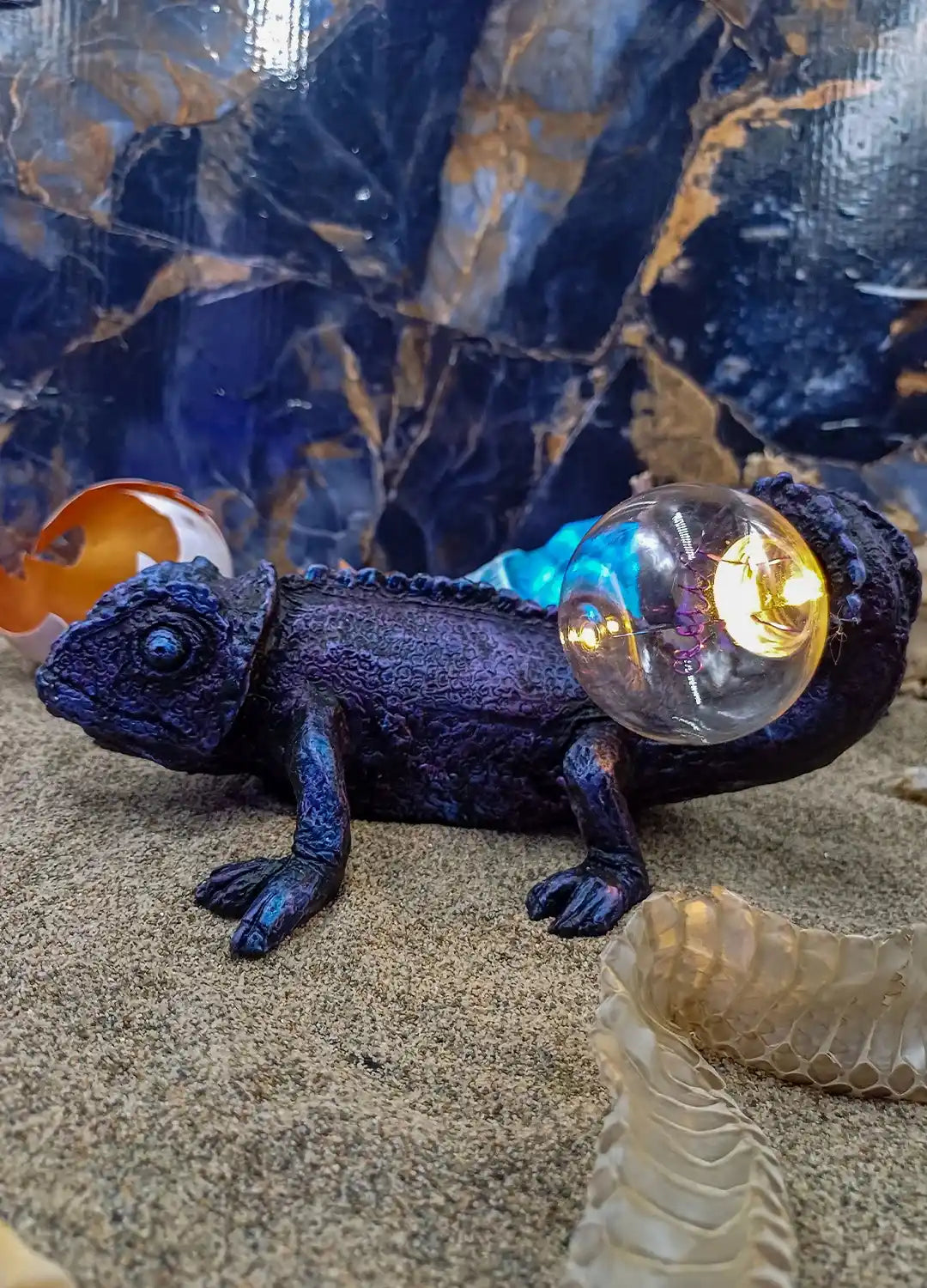 Chameleon lamp sculpture mounted on wall for mysterious cabinet-of-curiosities decor