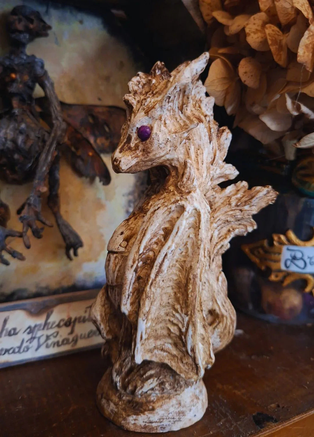 Side view of the handmade Wind Dragon resin sculpture with purple eyes and a fluid textured design, perfect for dark academia bookshelf decor.