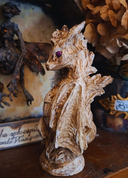 Side view of the handmade Wind Dragon resin sculpture with purple eyes and a fluid textured design, perfect for dark academia bookshelf decor.