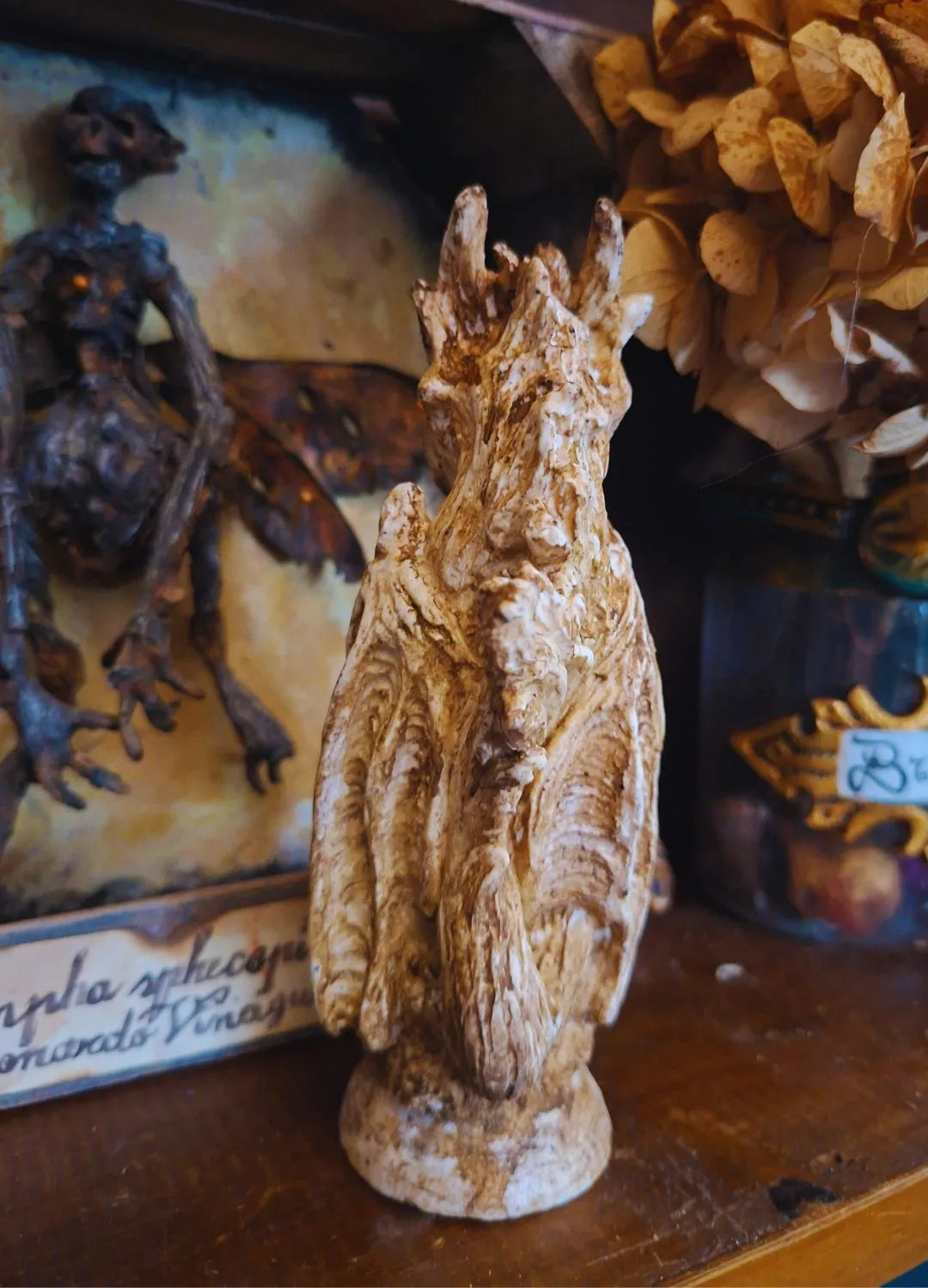 Three-quarters shot of the elegant Wind Dragon figurine, highlighting the smooth organic textures and flowing elements along its back.