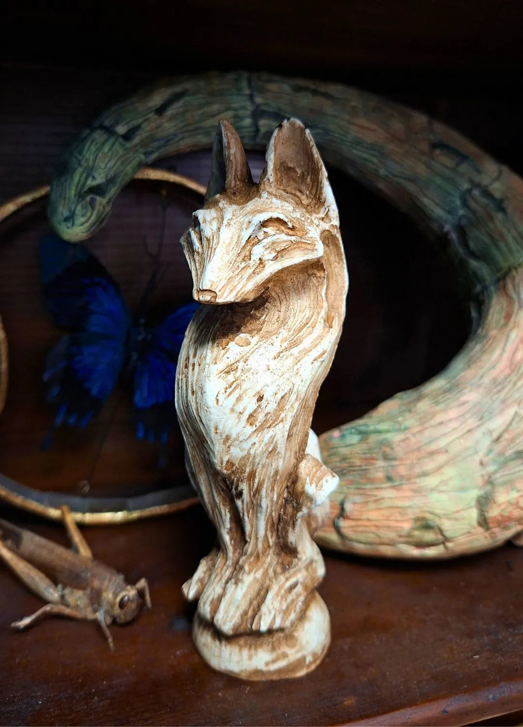 Close-up of a Wolf resin idol with a detailed weathered bone texture and stylized graphic carvings, suitable for a dark fantasy ritual altar.
