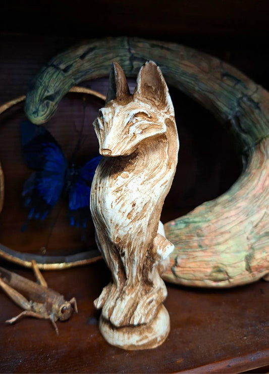 Close-up of a Wolf resin idol with a detailed weathered bone texture and stylized graphic carvings, suitable for a dark fantasy ritual altar.